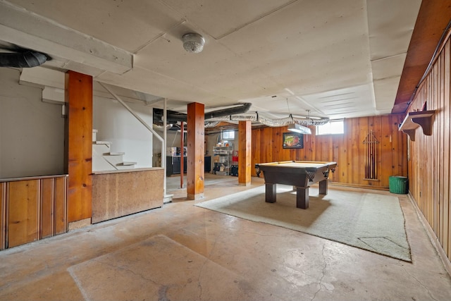 below grade area with pool table, stairway, and wooden walls