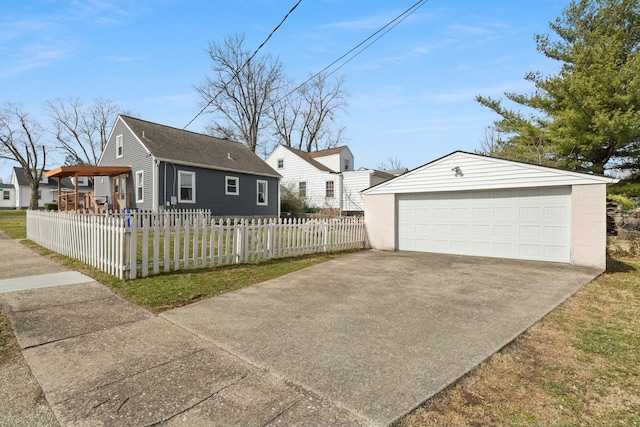 exterior space with a fenced front yard, a garage, and an outdoor structure