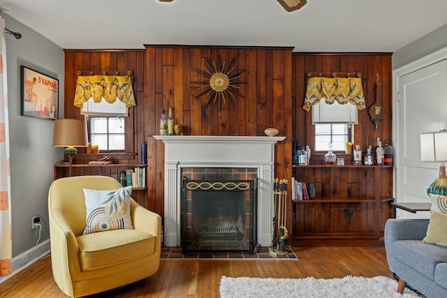 living area with a healthy amount of sunlight, a fireplace, and wood finished floors