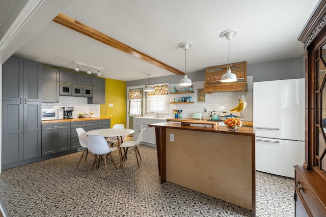 kitchen featuring white appliances, gray cabinets, butcher block countertops, beamed ceiling, and tasteful backsplash