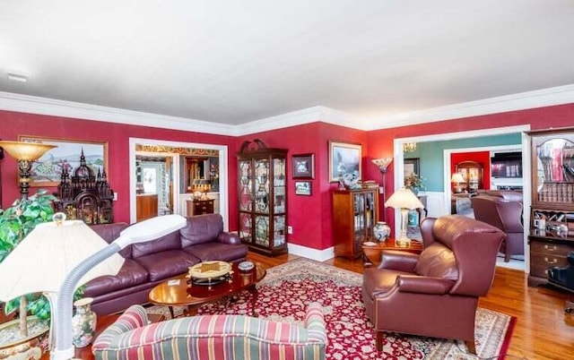 living room with wood finished floors and ornamental molding