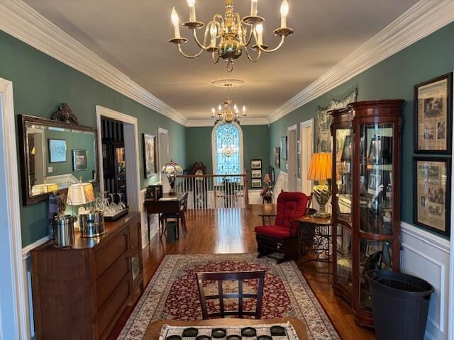 interior space featuring an inviting chandelier, wood finished floors, and ornamental molding