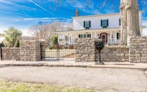 view of front of house with a fenced front yard and a gate