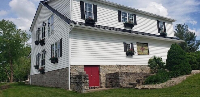 view of side of home featuring a yard