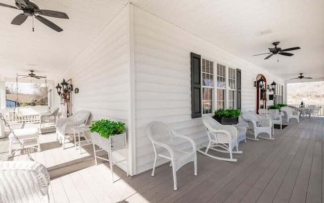 deck with a ceiling fan and covered porch