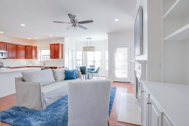 living room with recessed lighting, light wood-type flooring, and ceiling fan