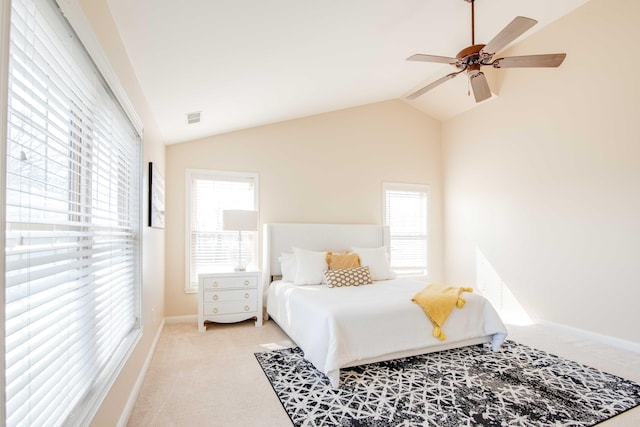 bedroom with visible vents, carpet flooring, multiple windows, and vaulted ceiling