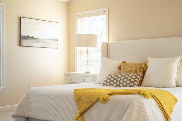 carpeted bedroom with baseboards