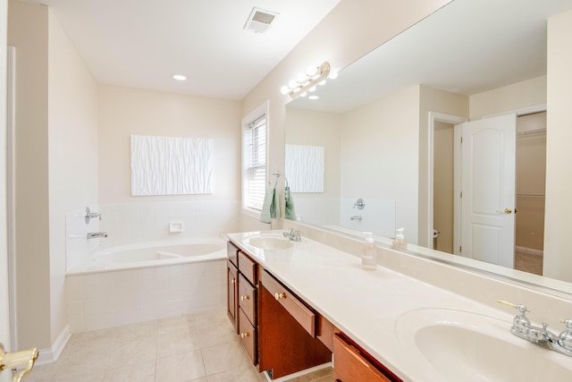 bathroom featuring a sink, visible vents, a bath, and tile patterned floors