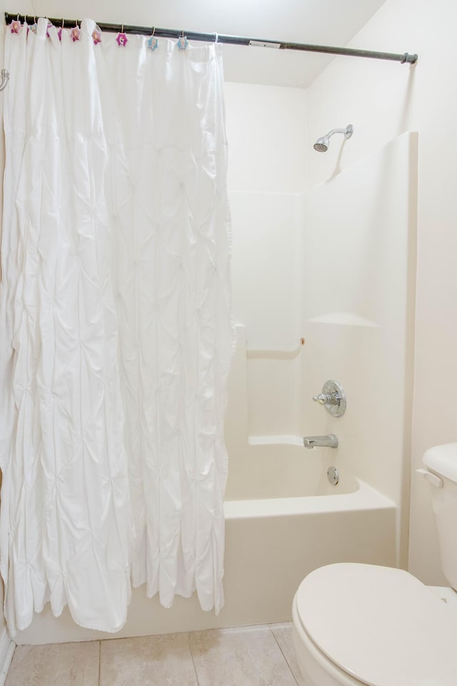 full bath featuring tile patterned floors, toilet, and shower / bathtub combination with curtain