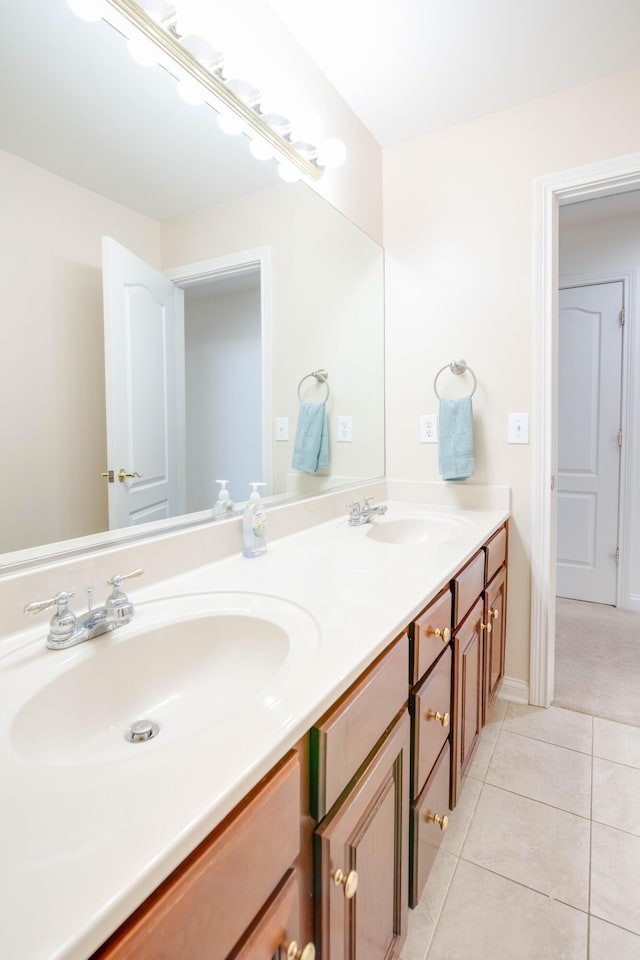 full bath with tile patterned flooring, double vanity, and a sink