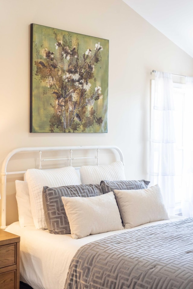 bedroom featuring multiple windows and vaulted ceiling