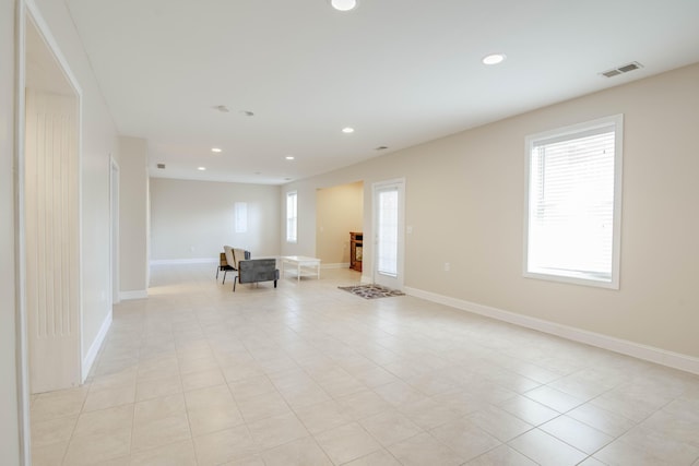 unfurnished living room featuring light tile patterned flooring, visible vents, recessed lighting, and baseboards