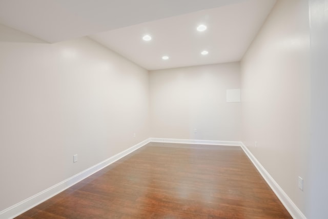 spare room with dark wood finished floors, recessed lighting, and baseboards