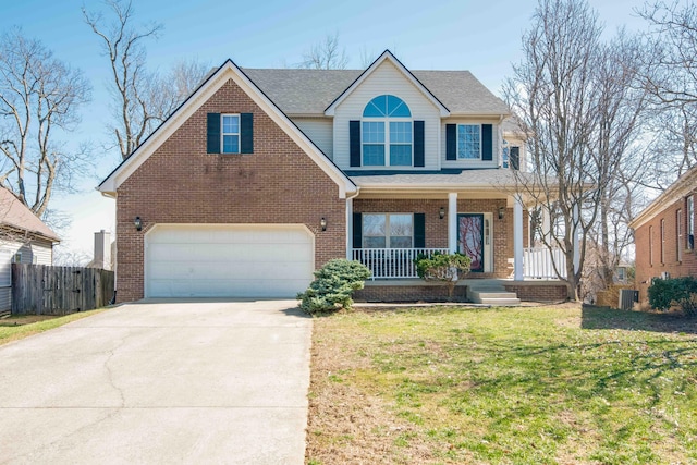 view of front of property featuring a front yard, fence, a porch, concrete driveway, and brick siding