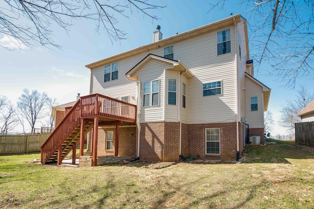 rear view of property featuring a lawn, a chimney, stairs, and fence