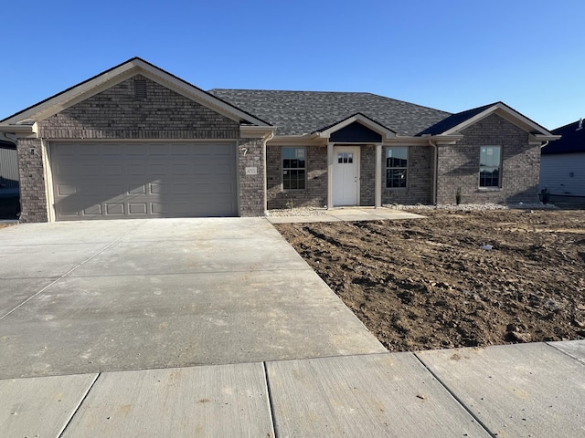 ranch-style house featuring brick siding, an attached garage, roof with shingles, and driveway