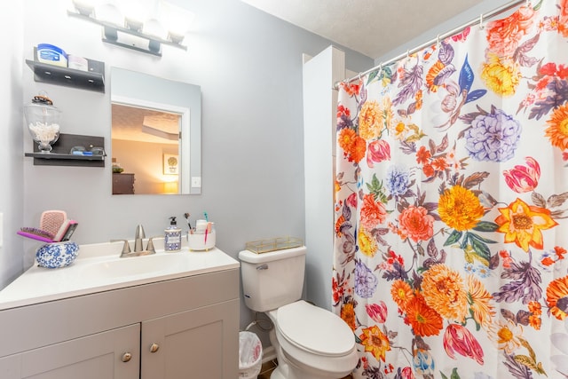 full bathroom with vanity, curtained shower, and toilet