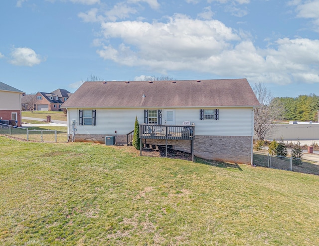 rear view of house with a yard, a fenced backyard, and a deck