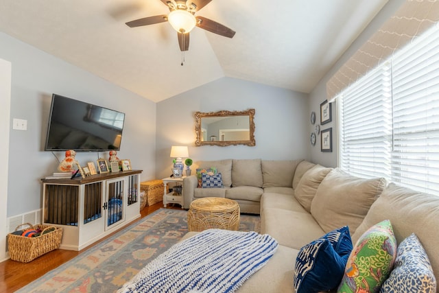 living room with visible vents, lofted ceiling, wood finished floors, and a ceiling fan