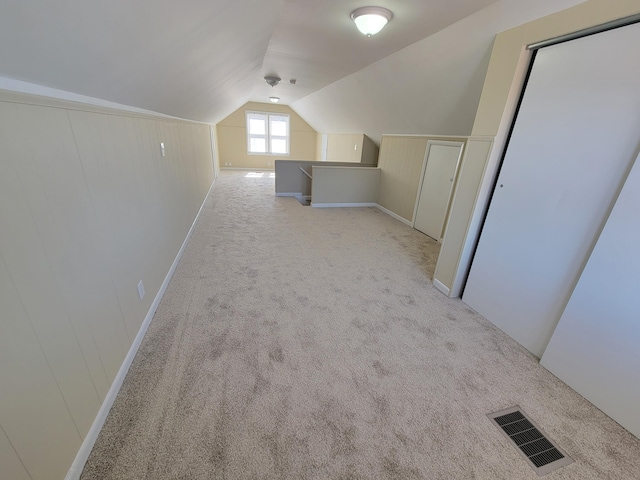 bonus room featuring visible vents, light carpet, and lofted ceiling