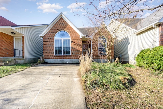 view of front of home with brick siding and driveway