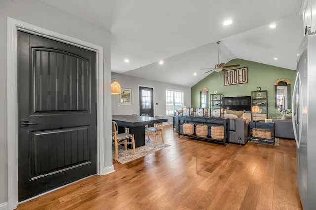 bedroom featuring vaulted ceiling, recessed lighting, wood finished floors, and freestanding refrigerator