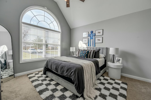 bedroom with lofted ceiling, carpet, and baseboards