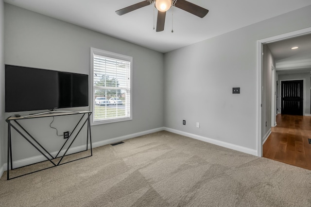 unfurnished living room featuring visible vents, baseboards, carpet, and ceiling fan