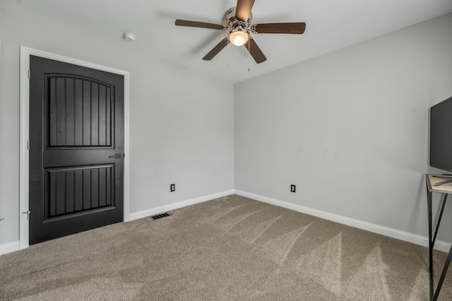 interior space with a ceiling fan, carpet, visible vents, and baseboards