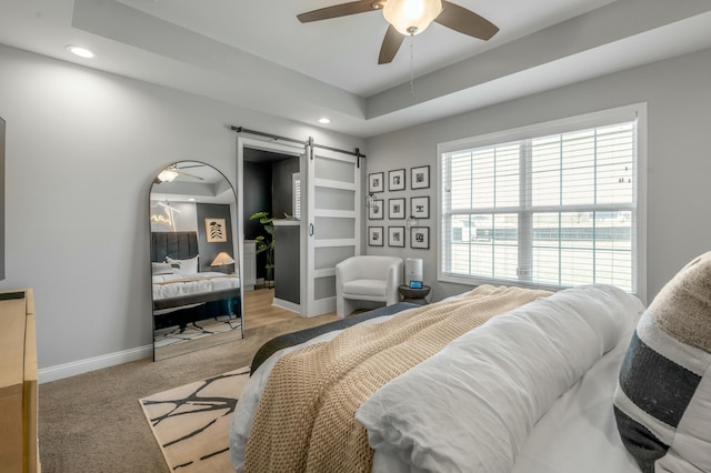 carpeted bedroom with recessed lighting, baseboards, a barn door, and a ceiling fan