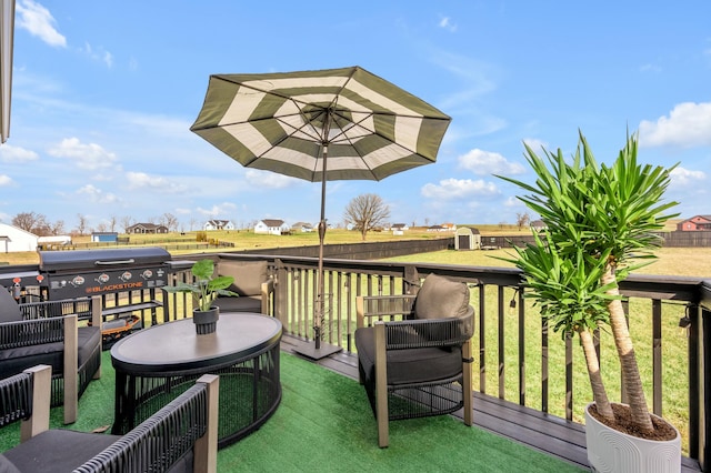 wooden deck featuring a lawn and area for grilling