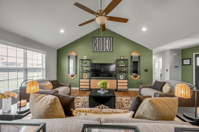 living room with vaulted ceiling, baseboards, ceiling fan, and wood finished floors