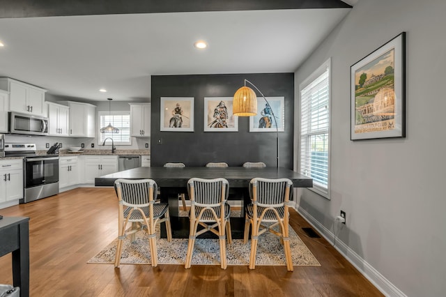 dining space featuring visible vents, recessed lighting, baseboards, and wood finished floors