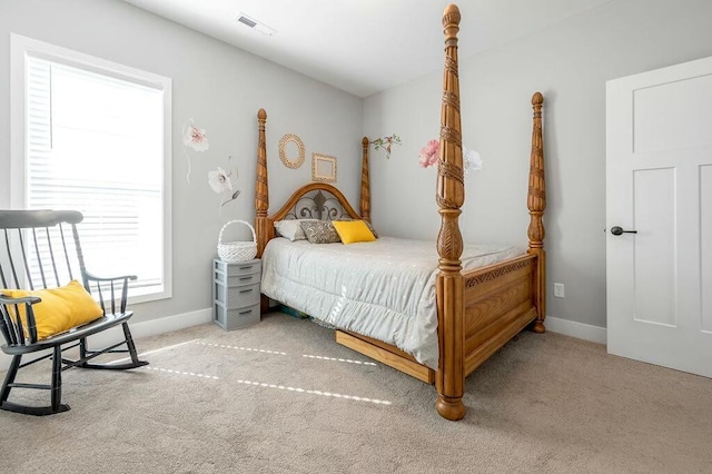 carpeted bedroom featuring visible vents and baseboards