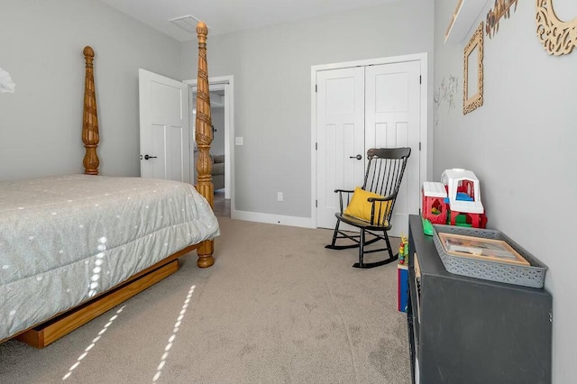 carpeted bedroom with baseboards and a closet