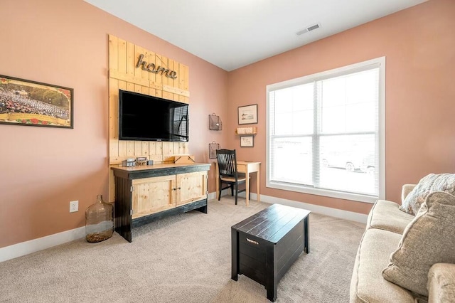 living room featuring baseboards, visible vents, and light carpet