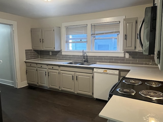 kitchen featuring dishwasher, light countertops, decorative backsplash, black / electric stove, and a sink