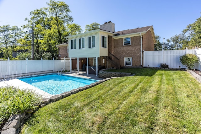 view of pool with a yard, a patio area, a fenced in pool, and a fenced backyard