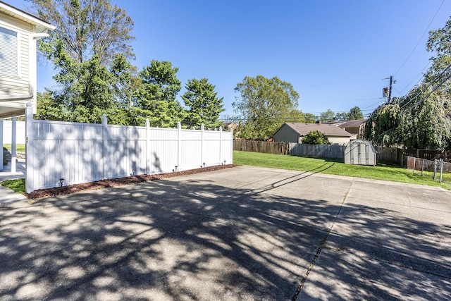 exterior space with a storage shed, a fenced backyard, and an outdoor structure