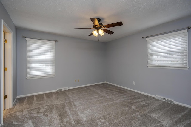 carpeted empty room with baseboards and visible vents