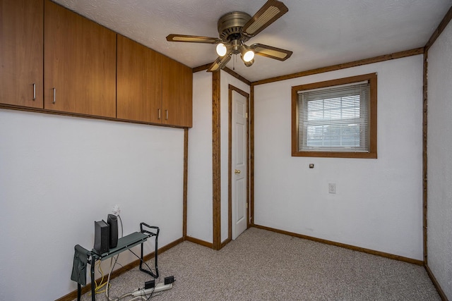 interior space with a ceiling fan, light colored carpet, and baseboards