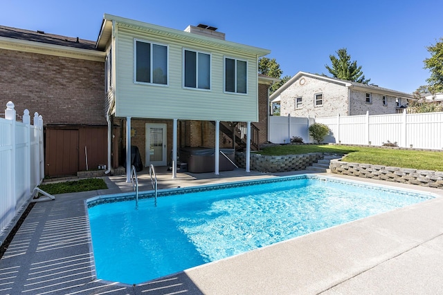 view of pool with a patio area, a fenced in pool, a hot tub, and a fenced backyard