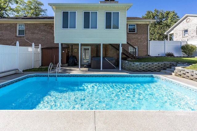 view of pool featuring a fenced in pool, a patio, a fenced backyard, and stairs