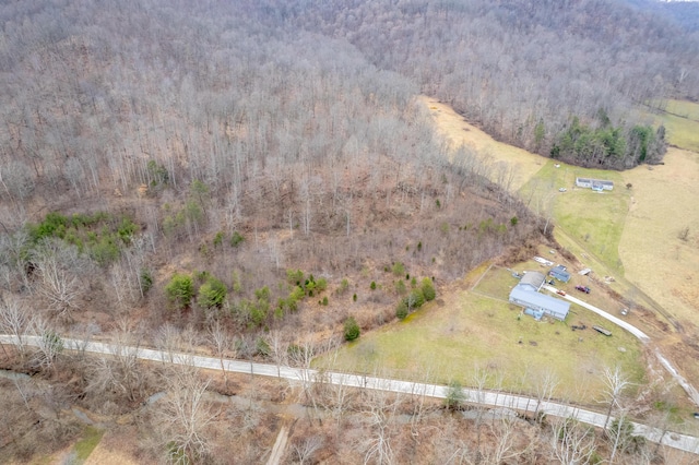 drone / aerial view featuring a view of trees