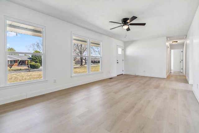 unfurnished living room with baseboards, light wood-style floors, and a ceiling fan