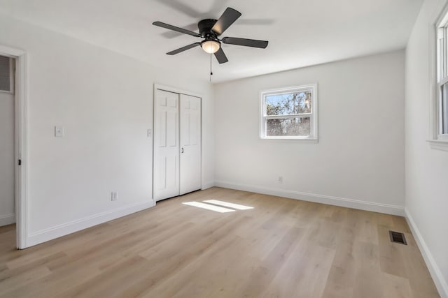 unfurnished bedroom featuring visible vents, baseboards, and light wood finished floors