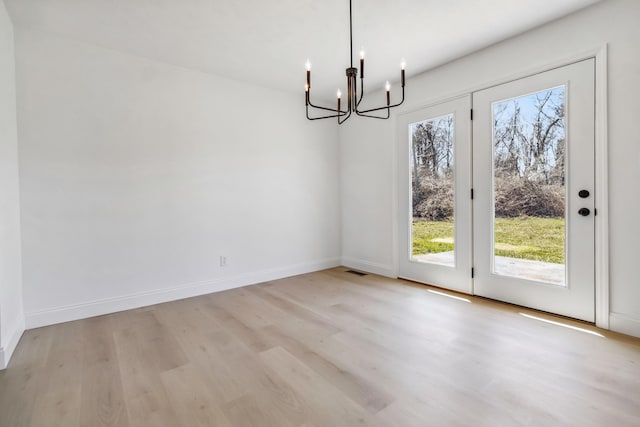 unfurnished dining area featuring light wood-style floors, baseboards, and a wealth of natural light