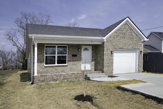 ranch-style house with a garage, brick siding, and roof with shingles