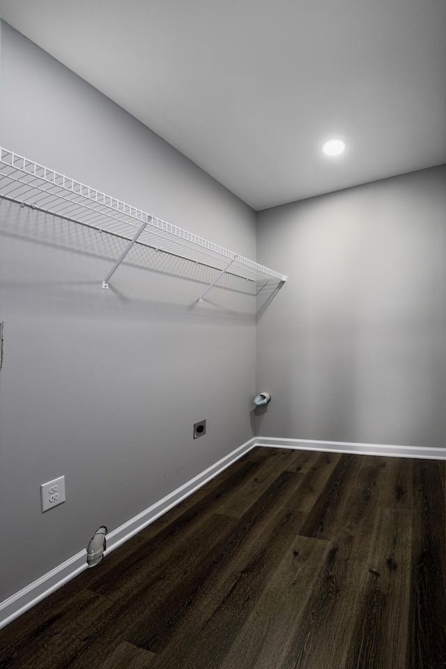 laundry room with dark wood finished floors, laundry area, baseboards, and electric dryer hookup